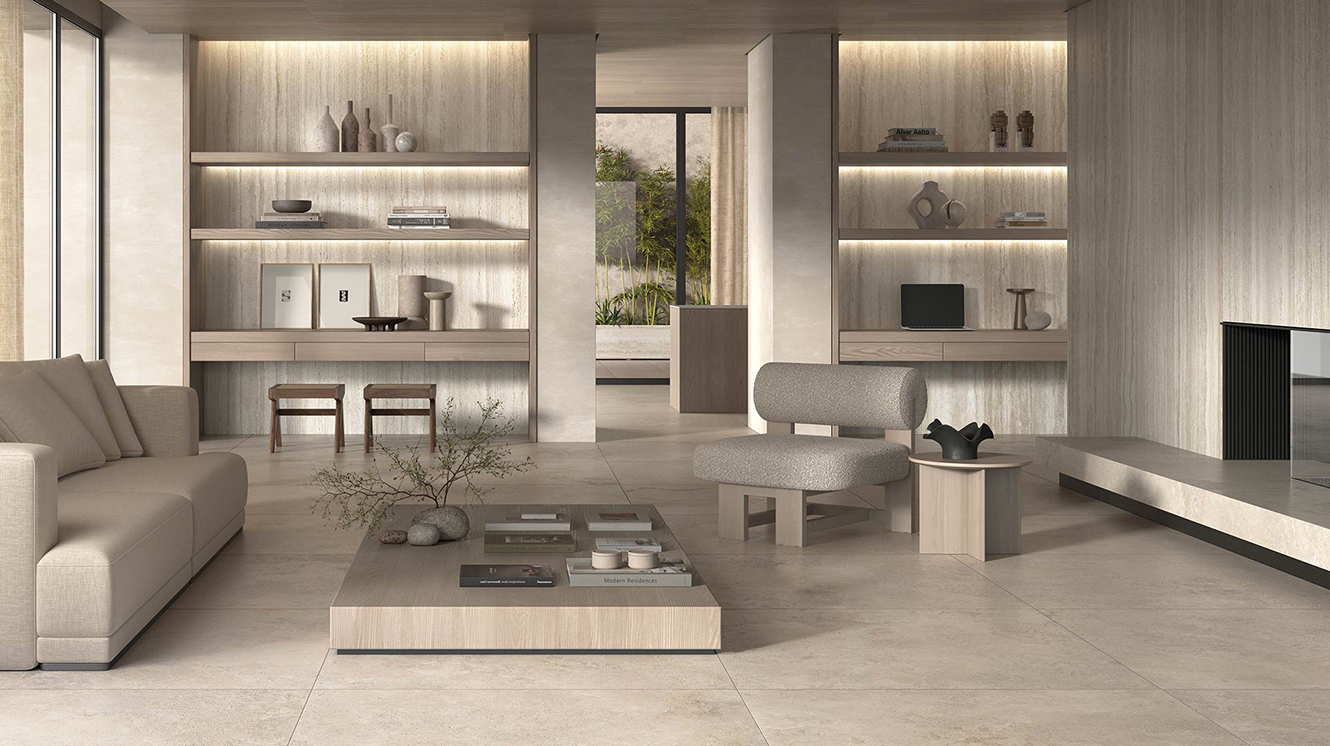 A contemporary living room enhanced by the warm and natural tones of the Nativa collection by Kronos Ceramiche. The stone-effect porcelain surfaces create a harmonious, refined, and welcoming environment.